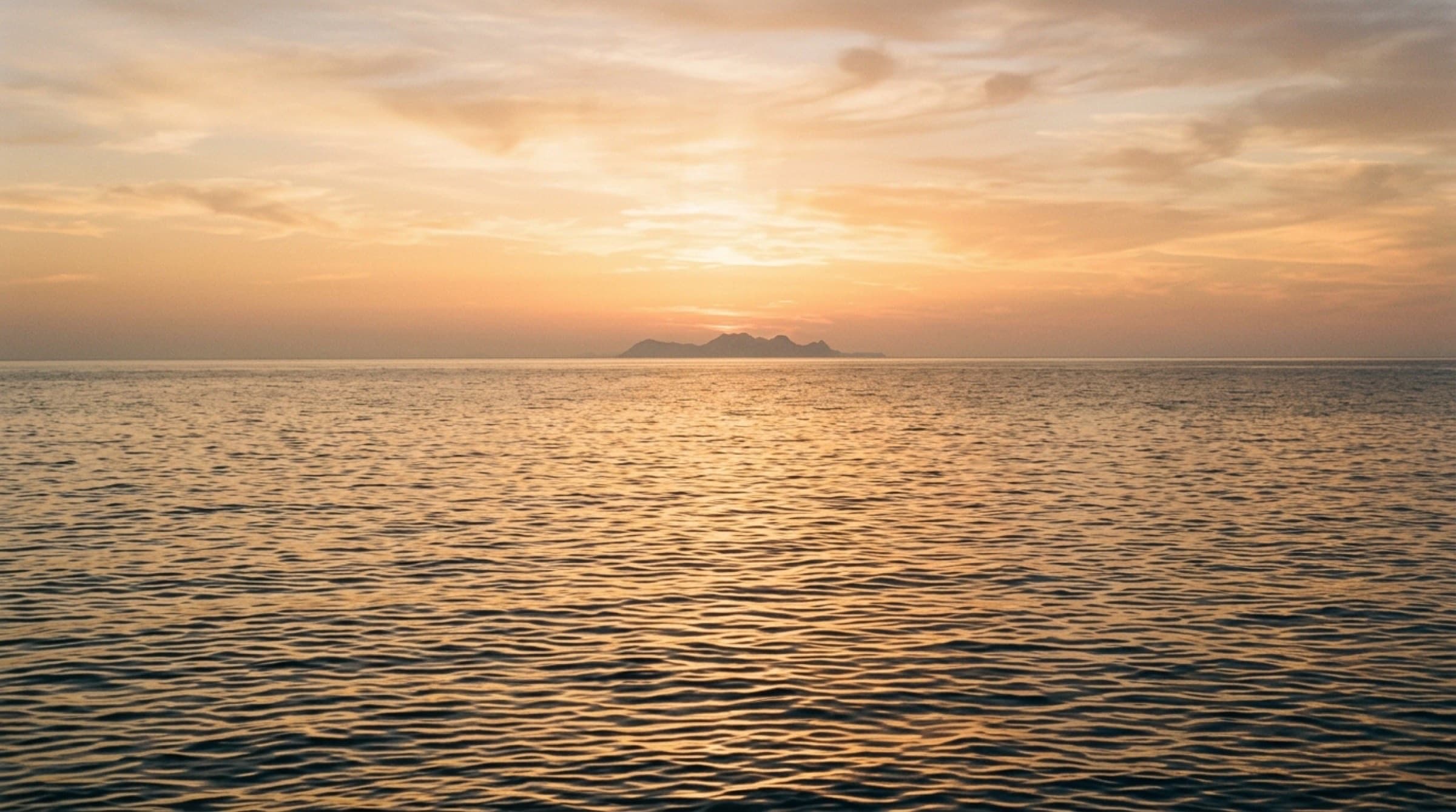 Open sea at golden hour — calm Aegean horizon